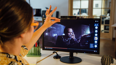 A person interacts with an application using touchless gestures.